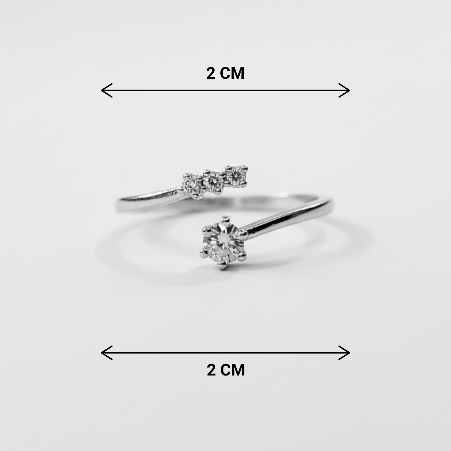 Two diamond rings with dimensions indicated on a light gray background