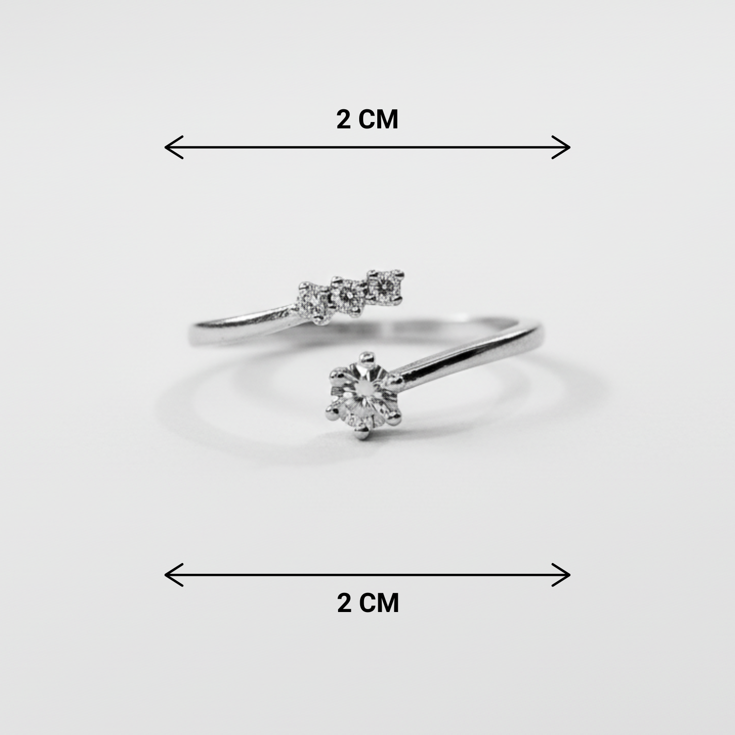 Two diamond rings with dimensions indicated on a light gray background