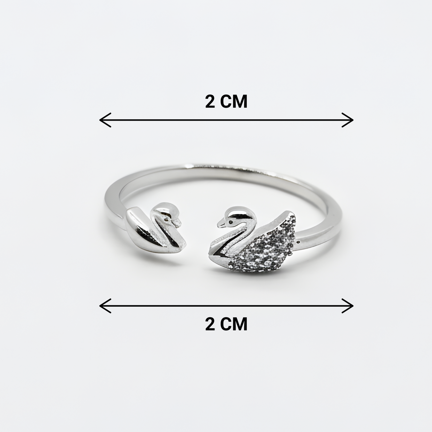 Silver swan-shaped ring with measurements on a white background