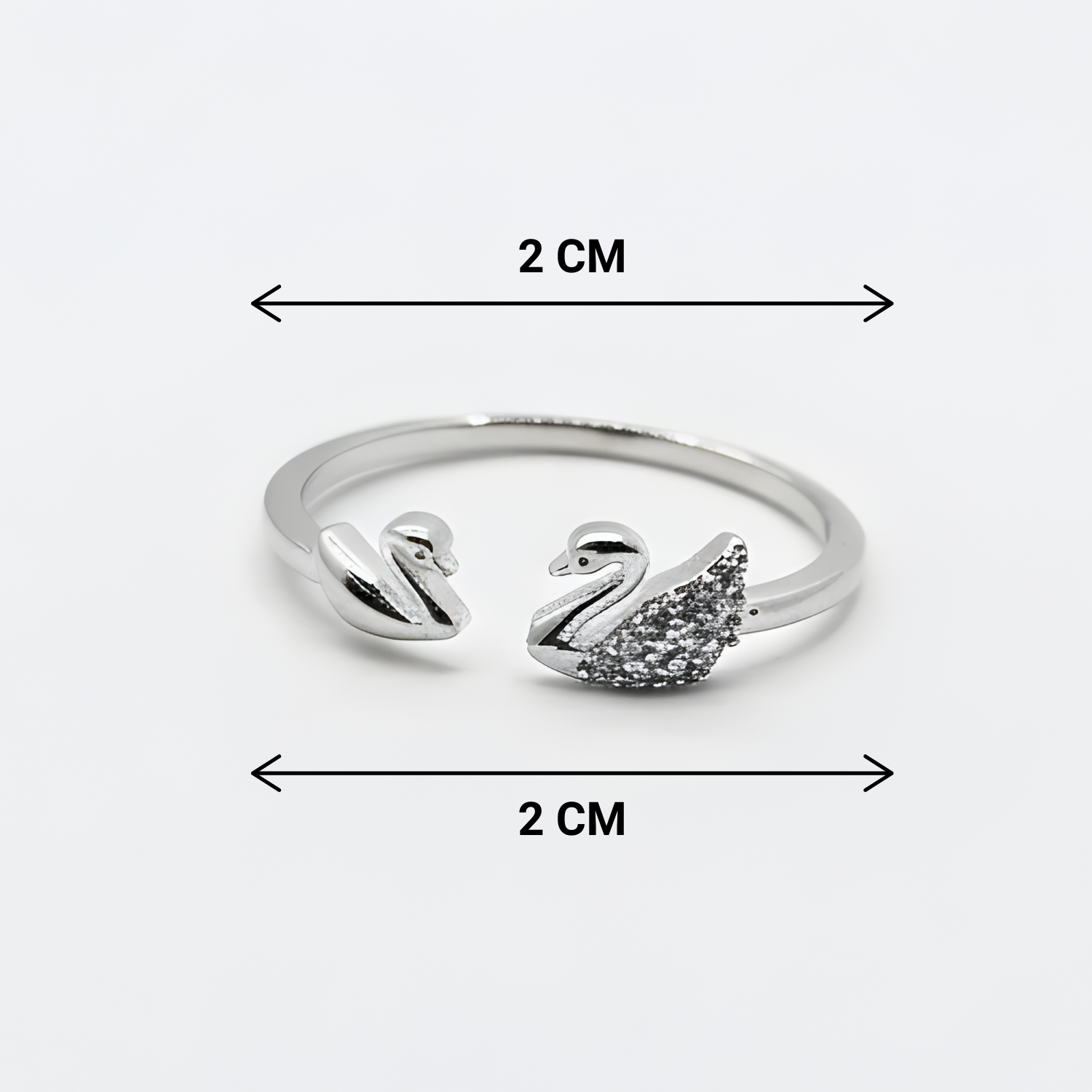 Silver swan-shaped ring with measurements on a white background