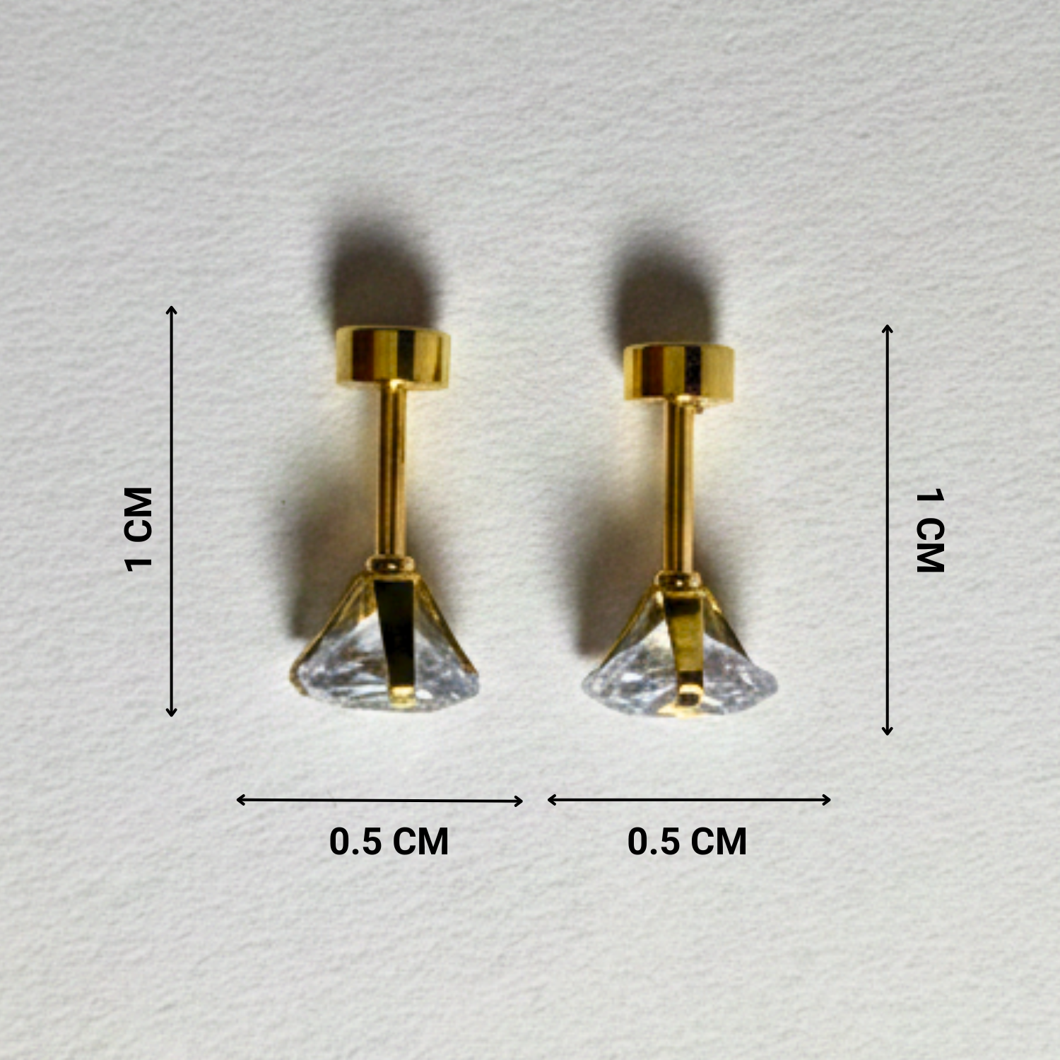 Gold earrings with clear gemstones on a light gray background, showing measurements.