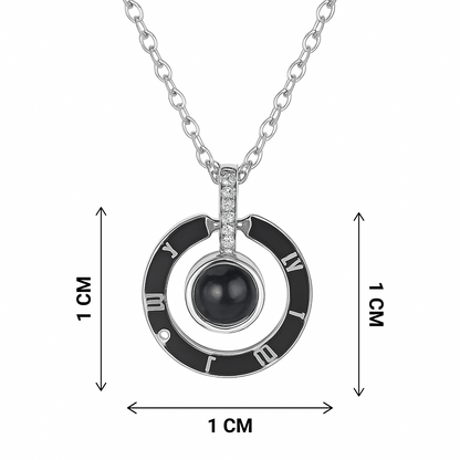 Necklace with a circular pendant featuring a black gemstone and Roman numeral design, shown with measurements on a white background.