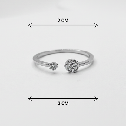 Silver ring with gemstones and measurement markings on a white background