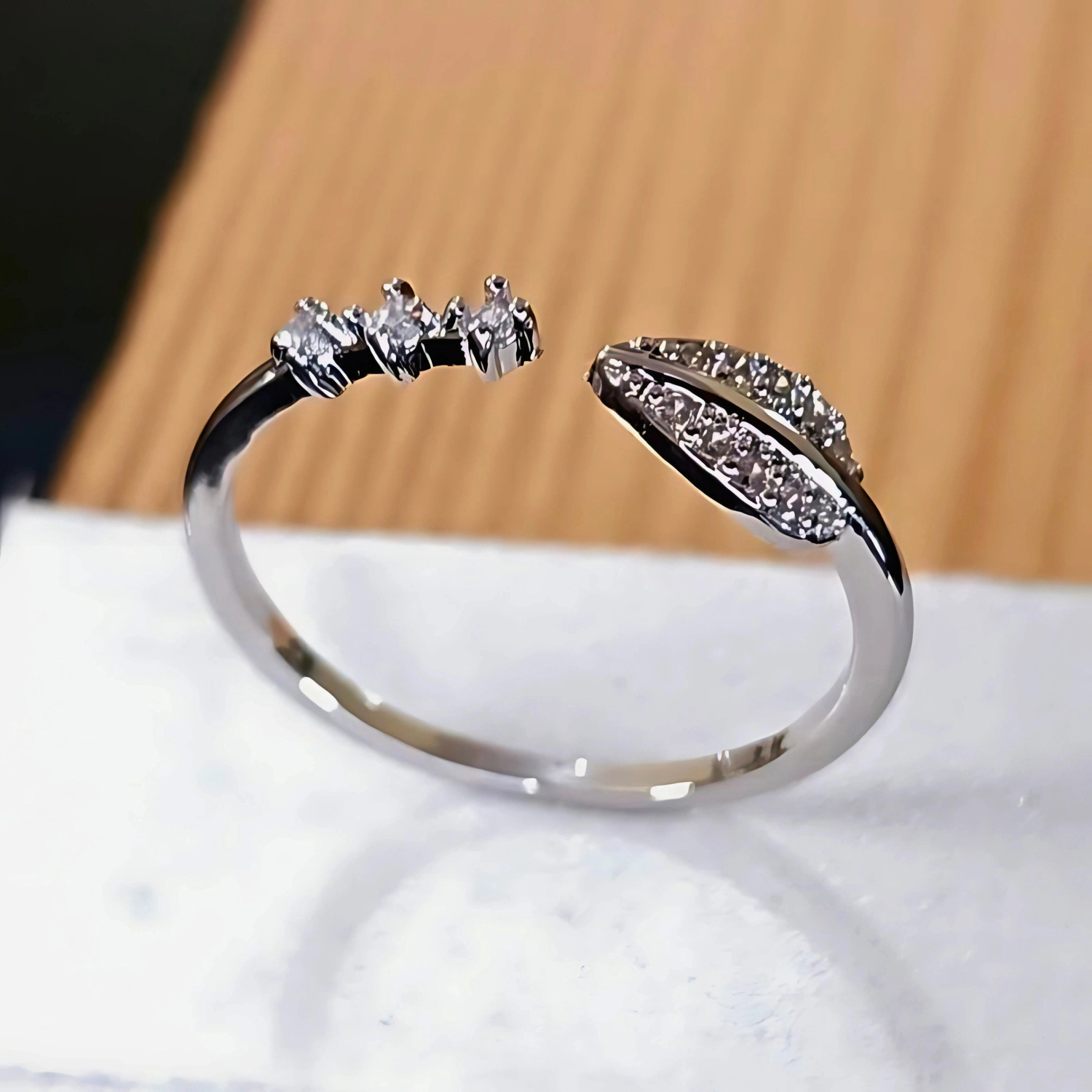 Silver ring with gemstones on a white surface