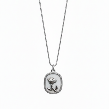 Silver necklace with a rose pendant on a white background