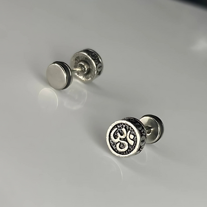 Pair of silver stud earrings on a light gray background