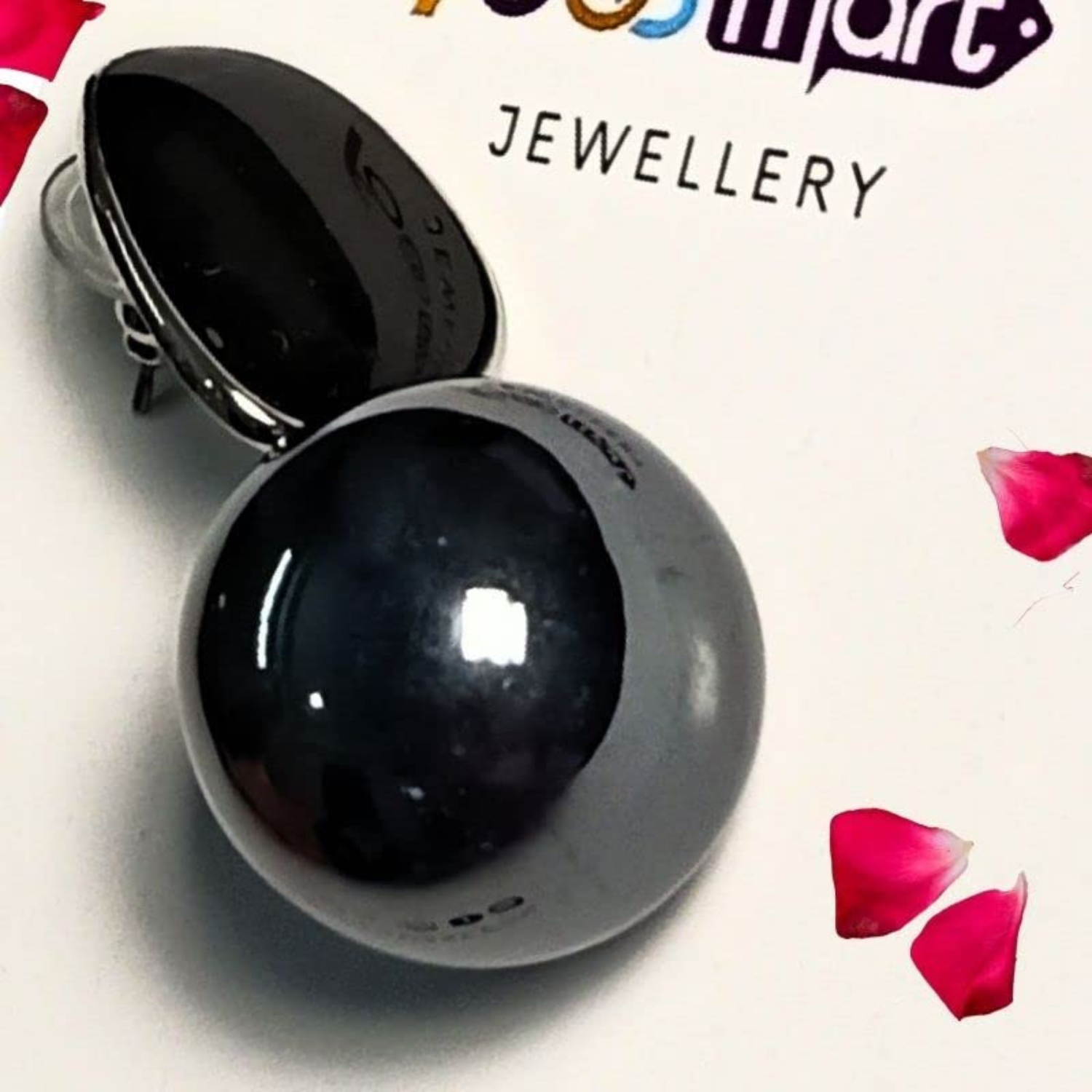 Black sphere with a white base on a white background with red petals, featuring 'Jewellery' branding.