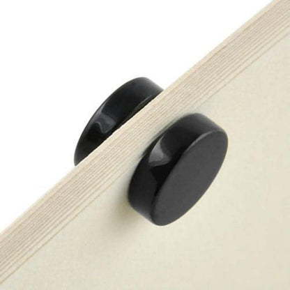 Black cabinet knob on a wooden drawer