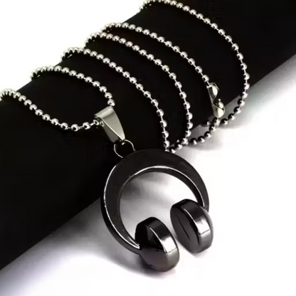 Black and silver pendant necklace on a black background