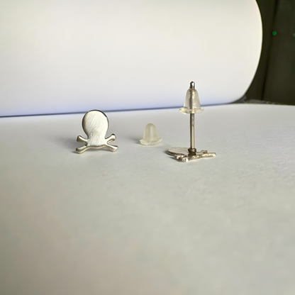 Three small metallic objects on a white surface with a blurred background