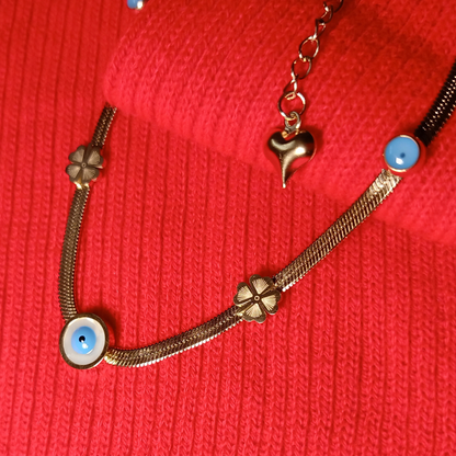 Bracelet with floral and heart charms on a red textured background
