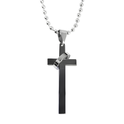 Black cross pendant on a silver chain against a white background