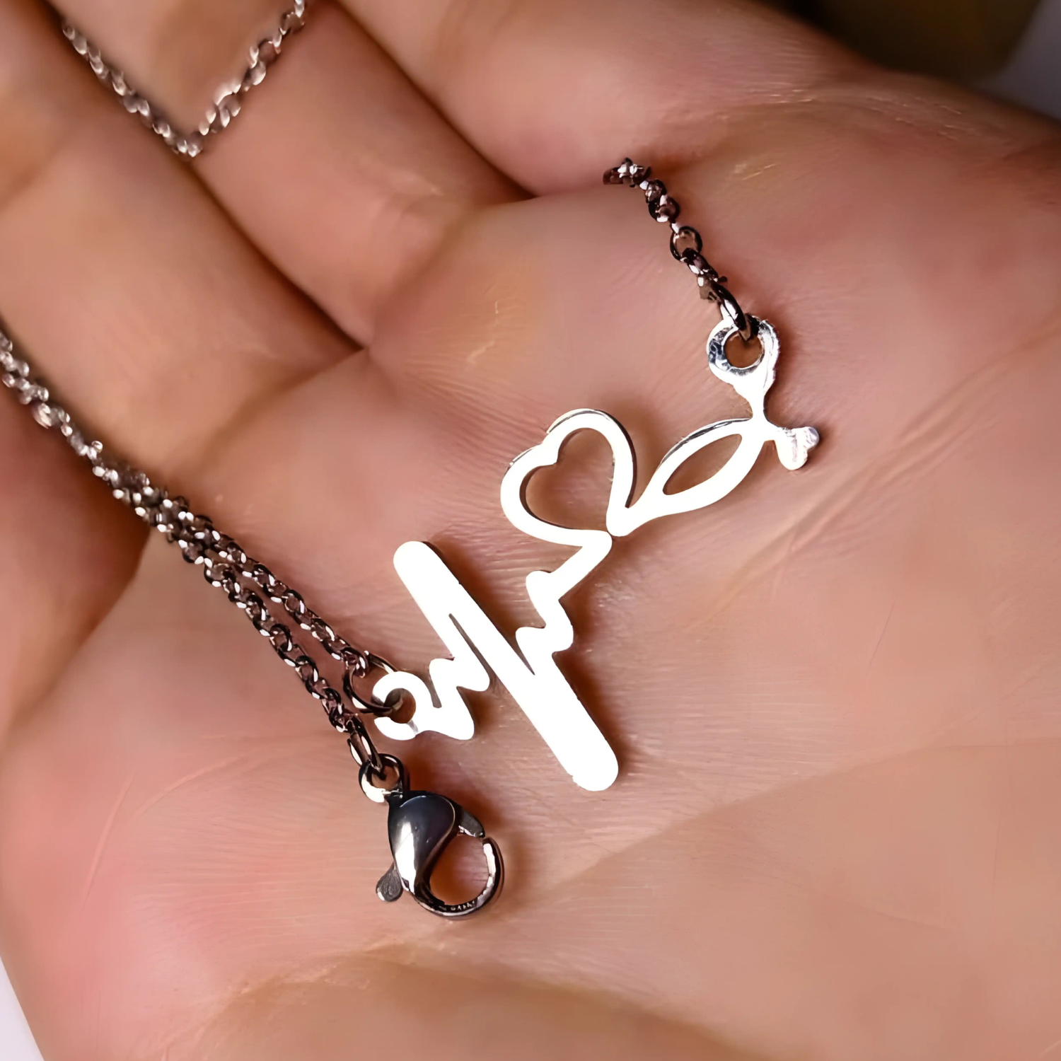 Necklace with a unique pendant held in a hand