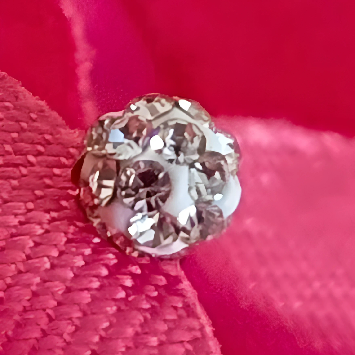 Close-up of a diamond on a red fabric background