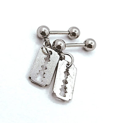 Silver belly button ring with razor blade design on a white background