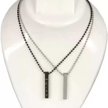 Two necklaces on a mannequin bust, one with black beads and the other with a silver bar pendant.