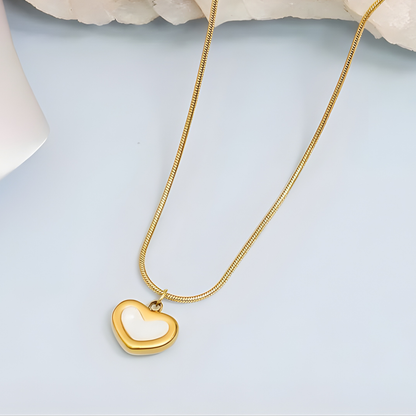 Gold heart-shaped necklace on a light blue background