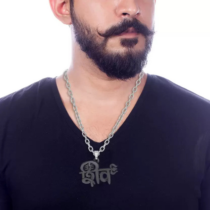 Man wearing a black shirt with a silver chain necklace on a white background