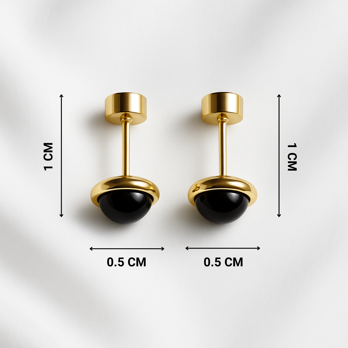 Pair of gold and black earrings with measurements on a white background