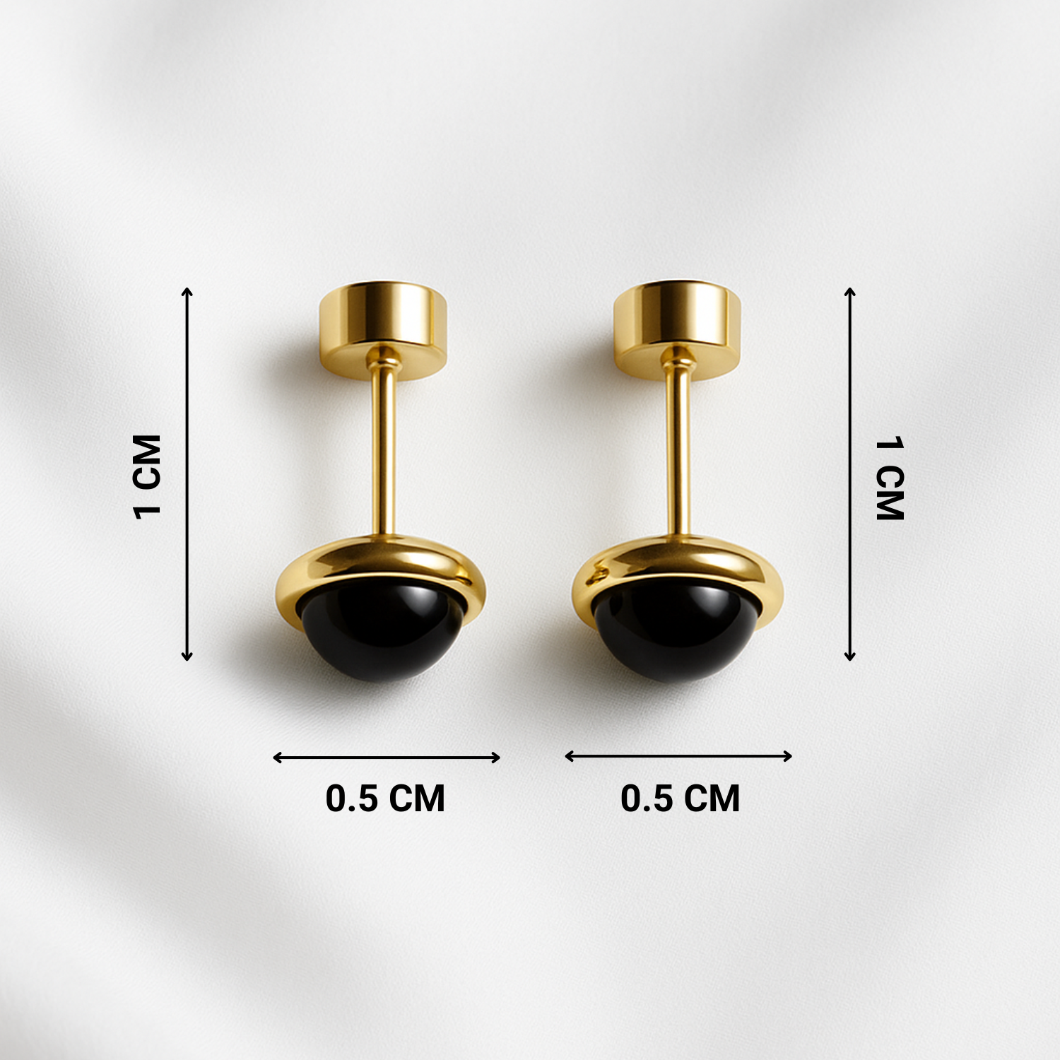 Pair of gold and black earrings with measurements on a white background