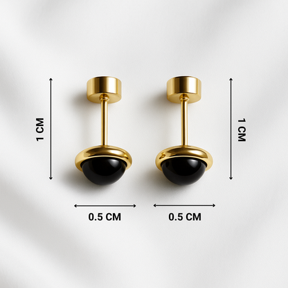 Pair of gold and black earrings with measurements on a white background