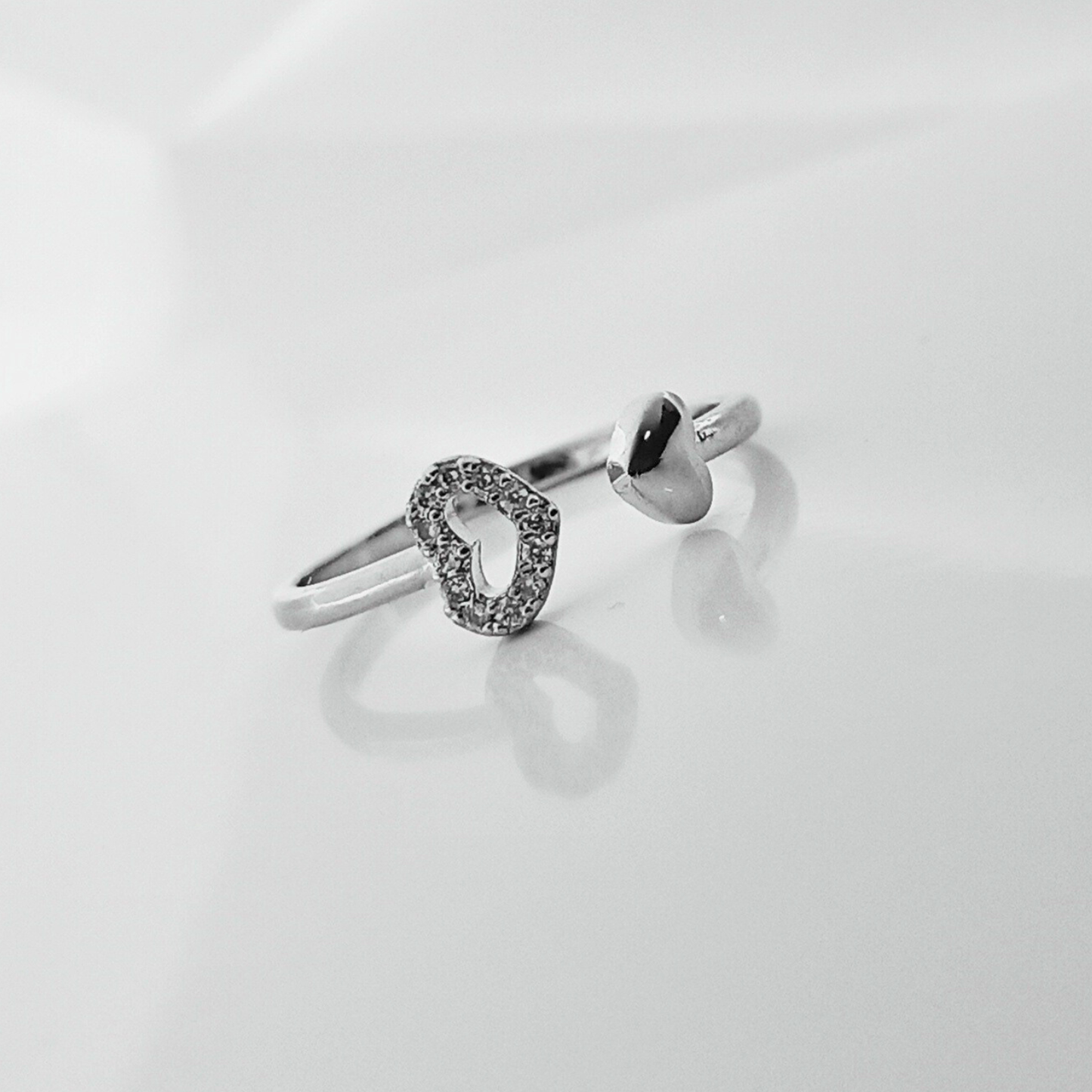 Silver ring with a unique design on a light gray background