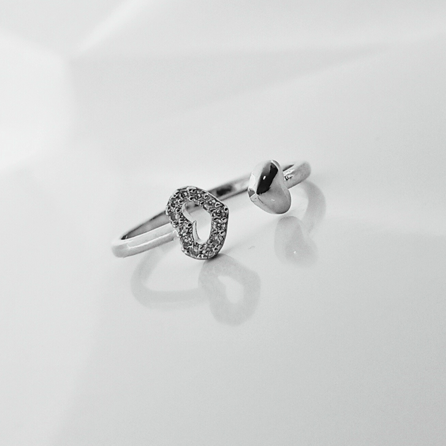 Silver ring with a unique design on a light gray background