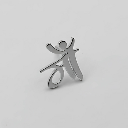 Silver pendant shaped like a stylized person on a light gray background