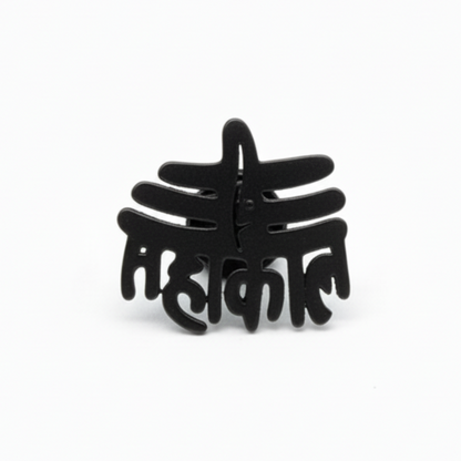 Black decorative item with intricate design on a white background