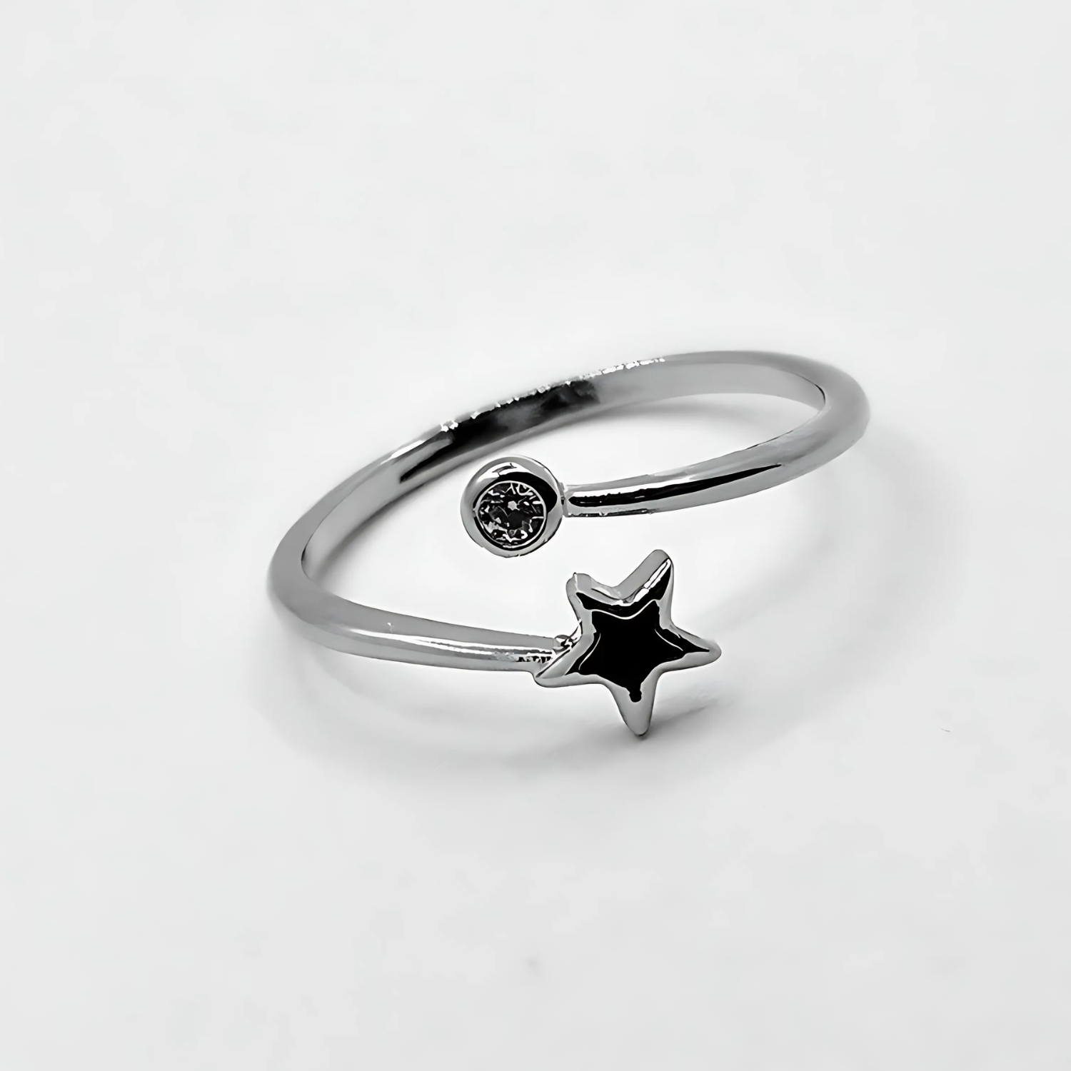 Silver ring with a star-shaped gem on a light gray background