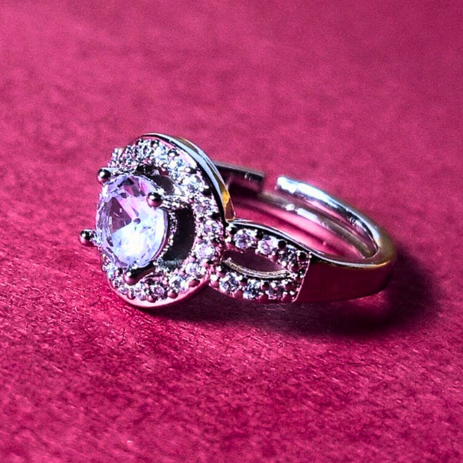 Silver ring with a gemstone on a pink background