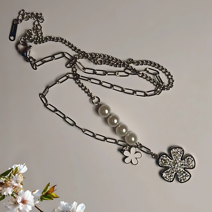 Necklace with floral pendants on a neutral background