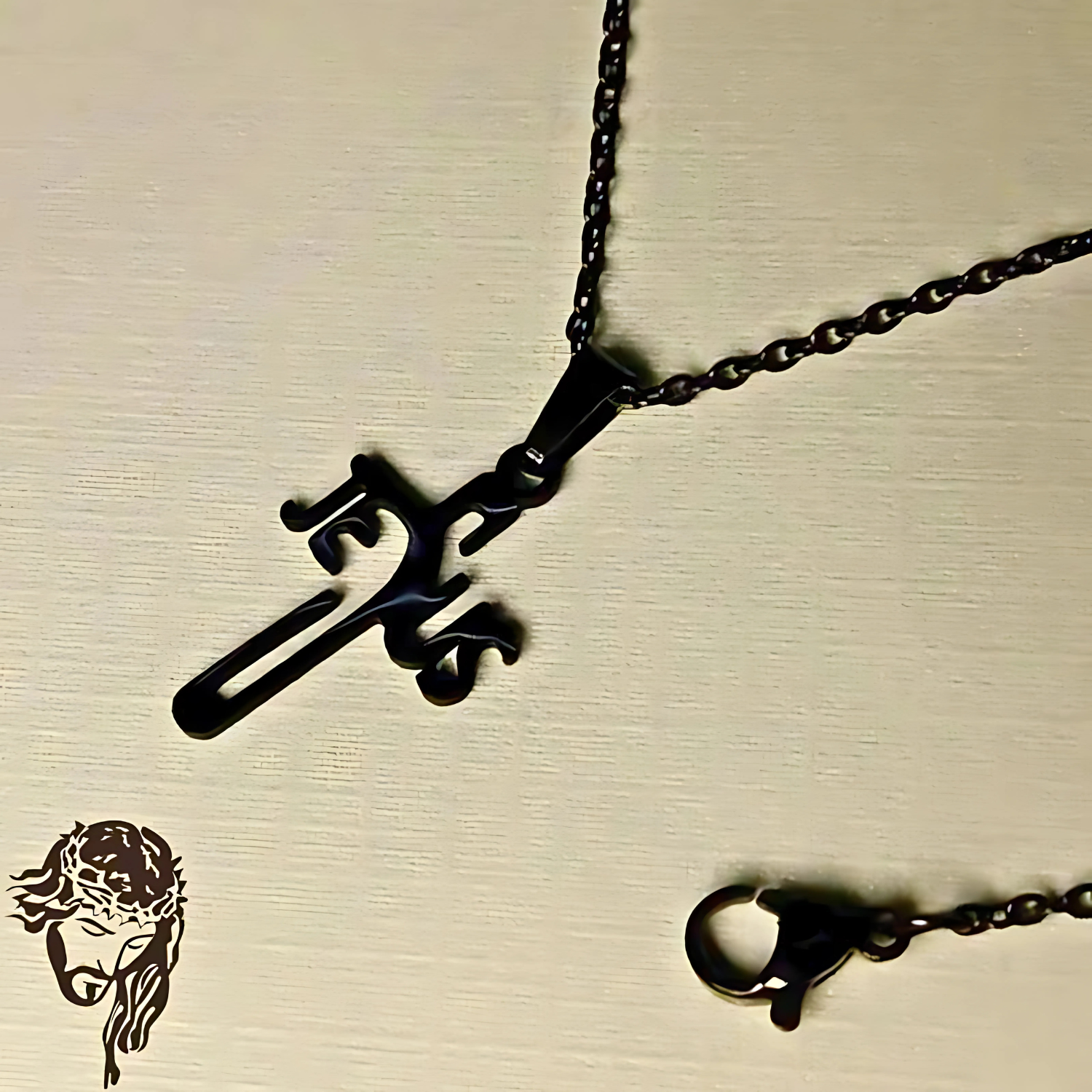 Black metal necklace with a unique pendant on a beige background