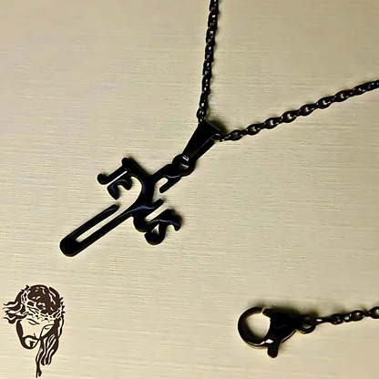 Black metal necklace with a unique pendant on a beige background