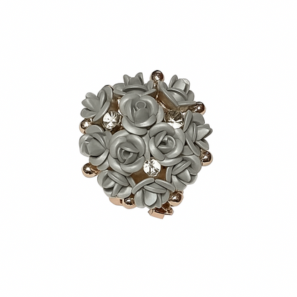 Decorative brooch with floral design on a white background