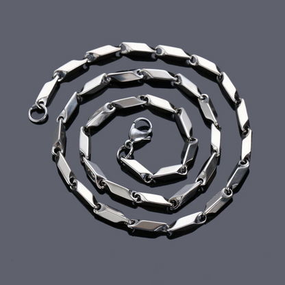 Silver chain necklace on a dark gray background