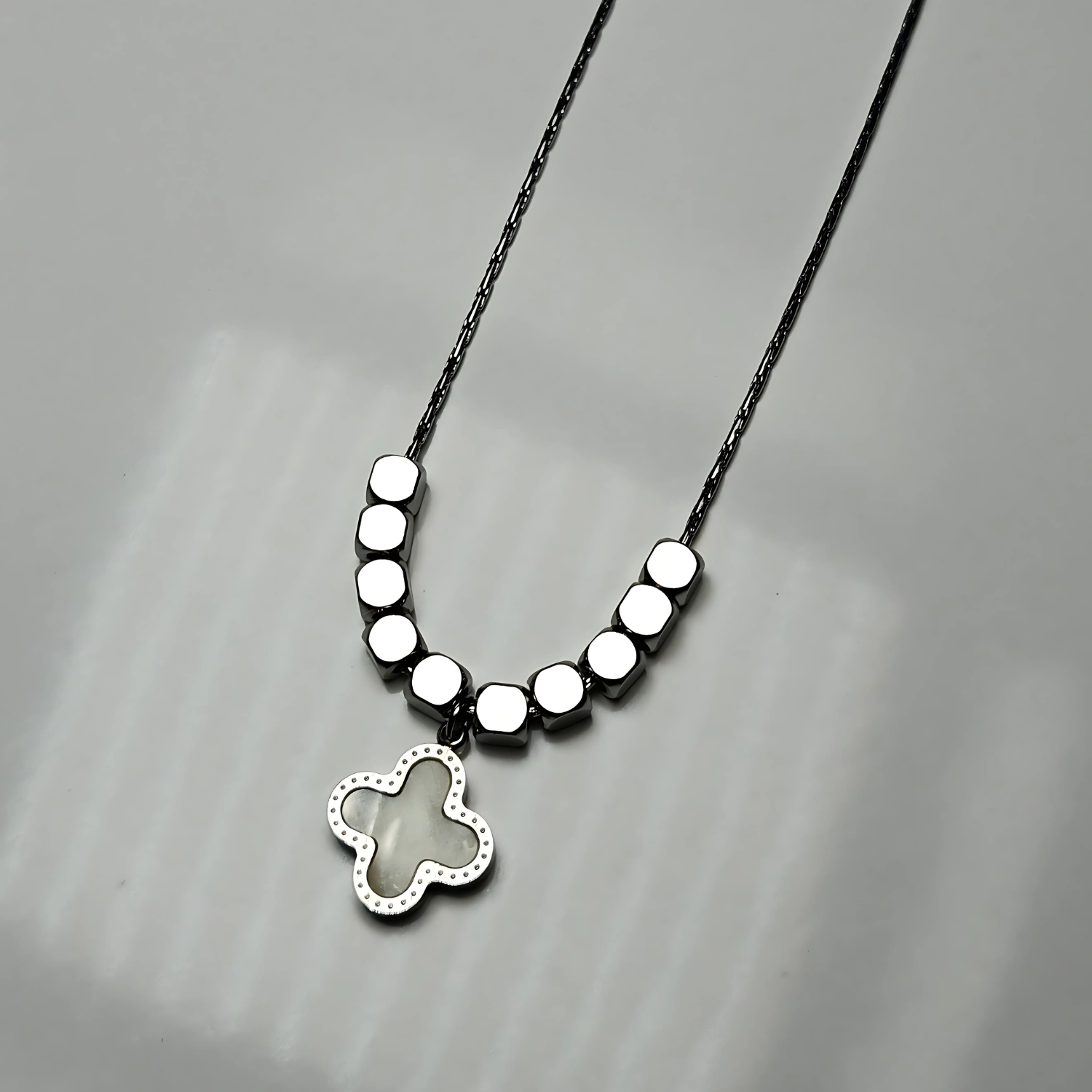 Necklace with a butterfly pendant on a gray background