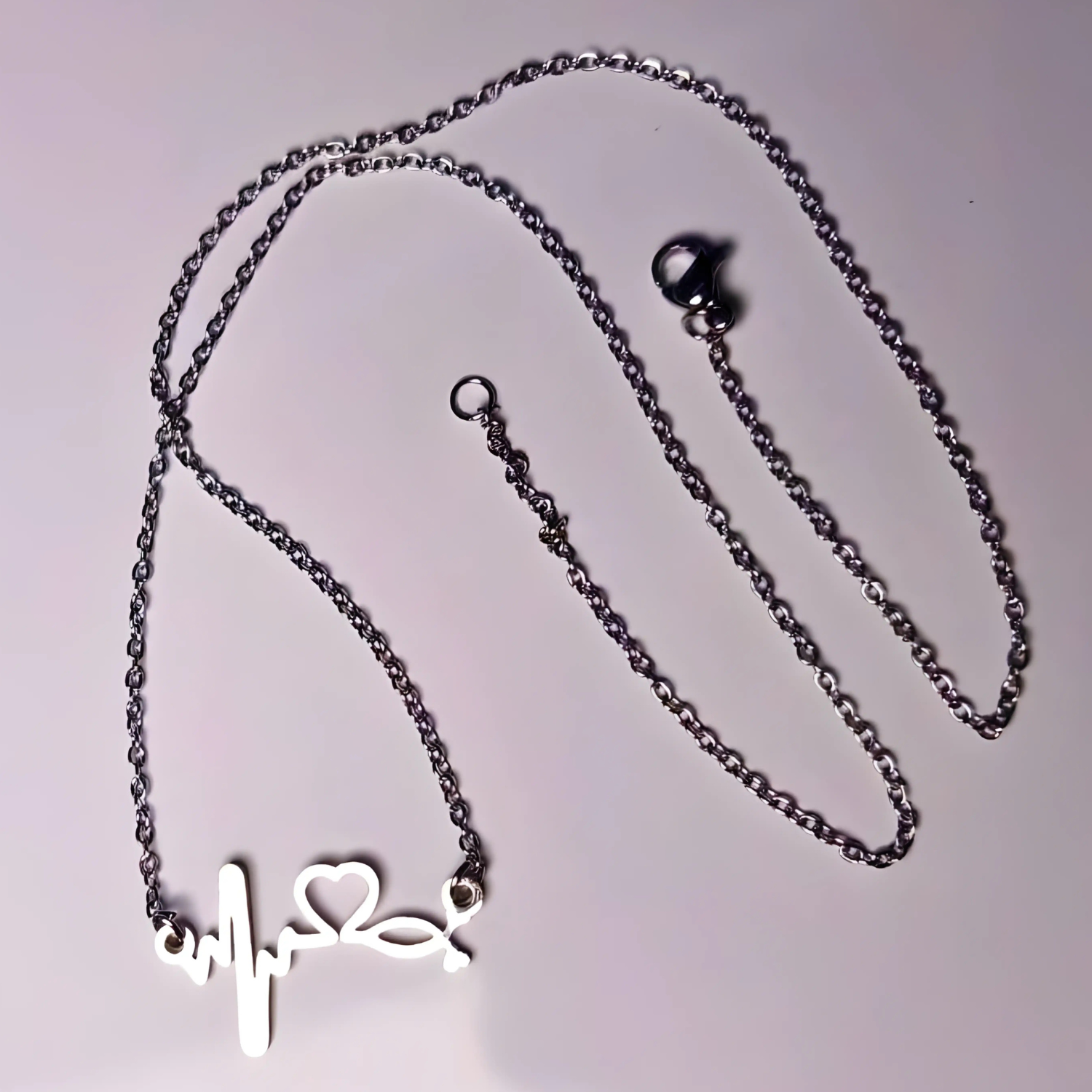 Necklace with a heart-shaped pendant on a light gray background