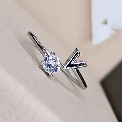 Silver ring with a diamond on a light background
