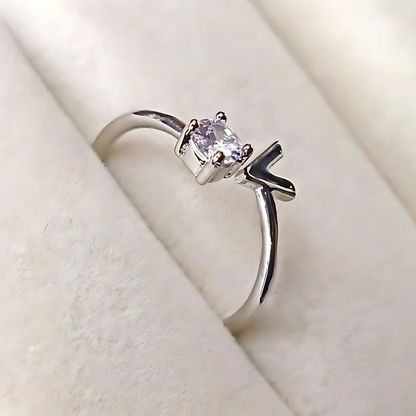 Silver ring with a gemstone on a soft beige background